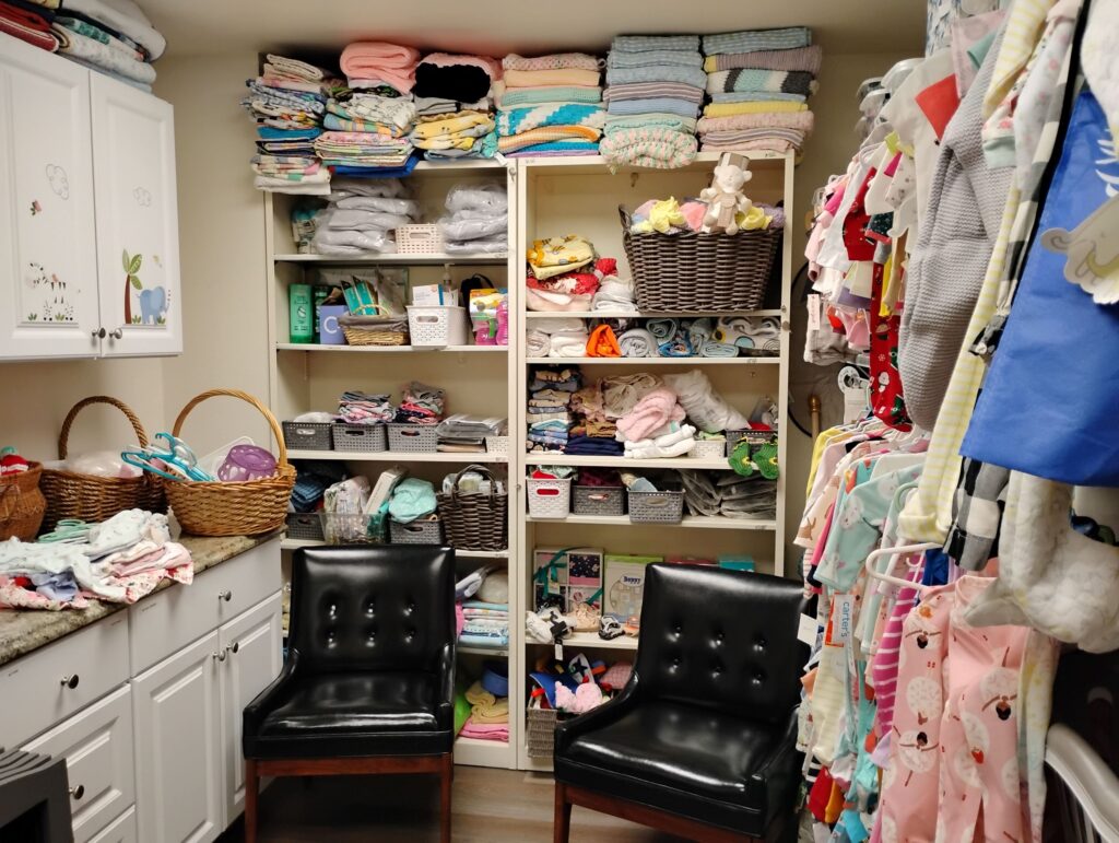 room with baby items and chairs